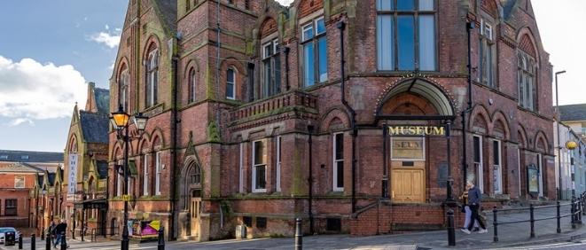 George Stephenson Memorial Hall mid shot from street. Red brick gothic style building.